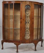 A 1950's retro walnut display cabinet having gilt decorated central glass. Raised on cabriole legs
