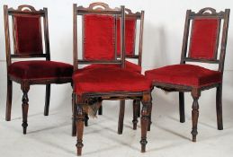 A set of 4 late Victorian mahogany dining chairs raised on turned legs with red velour seats and