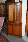 A Regency style yew wood corner cabinet. Plinth base having upright body with large double doors