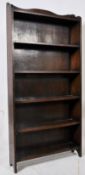 A large 1920's oak open window library bookcase. Shaped sides with multiple fixed shelves having
