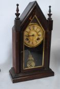 A 19th century Ansonia American gingerbread clock having an 8 day movement set within a spire case