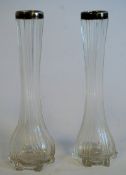 A pair of fluted glass vases, each having a hallmarked silver rim