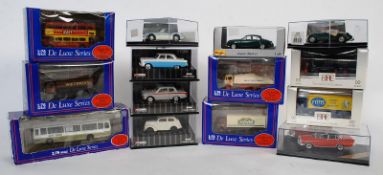 A collection of diecast toy cars and other vehicles to include De Luxe Series lorries and coaches (
