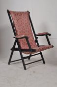 A Victorian ebonised mahogany steamer chair / campaign chair. The folding frame upholstered in an