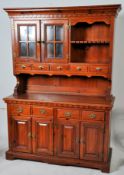 A contemporary large hardwood welsh dresser. The base with assorted drawers and cupboards under an