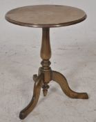 A large 19th century apprentice piece solid brass tilt top wine table. Raised on a tripod base