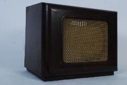A vintage faux wood style bakelite radio / amplifier speaker.
