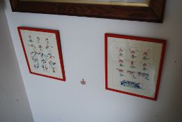 A pair of framed prints of cartoon rugby sporting scenes.