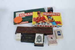 A collection of vintage games to include old crib board, playing cards, scrabble etc