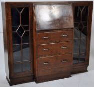 A 1930's oak bureau bookcase cabinet. The upright body having end glass display cabinets flanking