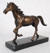 A 20th century study in metal of a horse on a marble plinth base.