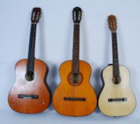 3 Spanish style acoustic nylon stringed guitars, one having a cream carry case.