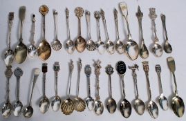 A collection of souvenir spoons to include scallop dished, enamel topped and others