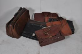 A vintage leather gladstone bag together with a collection of assorted leather gentlemans attache