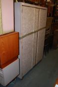 A pair of 1960's Melamine wardrobes, one double and one single. Together with the matching