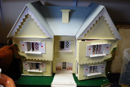 A 20th century childs dolls house with opening front, each room with battery powered electric