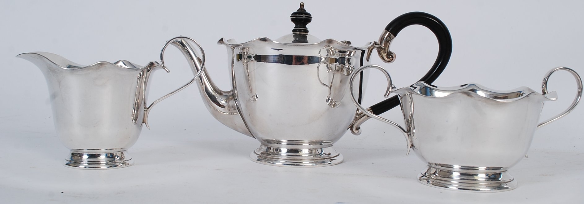 A James Dixon & Sons silver plate tea service to include teapot, creamer and sugar bowl.