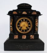 An antique black slate and marble mantel clock with marble corinthium columns to sides.