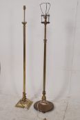 Two 19th century Victorian brass standard lamps. One with round base and turned stem, the other in