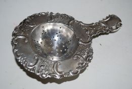 A 19th century German rococo silver hallmarked 930 / 925 tea strainer. German silver marks to handle