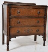 A 1920's Jacobean revival oak chest of drawers. Raised on tall turned legs with carved detailing
