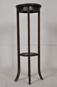 An Edwardian mahogany torchere / jardiniere. Raised on tapered legs with circular tiers to base