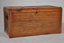 A 20th century handmade pine and panelboard blanket box / turnk having hinged lid with clasp to