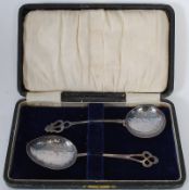 A pair of Arts & Crafts hallmarked silver spoons of handbeaten construction with pierced stems and