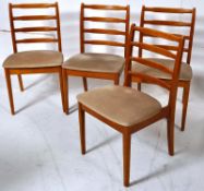 A set of 4 retro dining chairs in light beech wood having slatted back rests and velour padded
