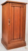 An Edwardian walnut pot cupboard / bedside cabinet. Pinth base with upright cabinet