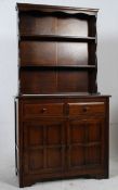 A mid 20th century oak welsh dresser. Drawers and cupboard to base with upright plate rack to the