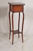 An Edwardian mahogany inlaid torchere / jardiniere plant stand raised on sabre supports. H92cm x