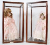 Two porcelain dolls both in original clothing and individual display cases