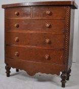 A Victorian bow front mahogany chest of drawers raised on turned legs with knob handles to the