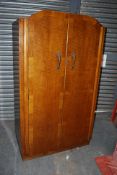 A 1930's Art Deco oak bachelors wardrobe having fitted haberdashery drawers to the interior with