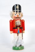 A 20th century wooden made nutcracker soldier. Stamped Made In GDR to base.