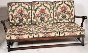 An Ercol Sofa settee daybed  in the Jacobean revival style having turned legs united by stretchers