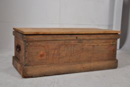 A Victorian pine blanket box with plinth base, carry handles to sides all being under a later hinged