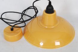 A contemporary Industrial style ceramic glazed hanging wall light pendant in dusky yellow