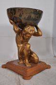 An unusual large globe of rococo style bearing Atlas set on plinth carrying the world ( half) Ideal