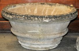 A large garden stone planter of basket form together with a garden ornament in the form of a car