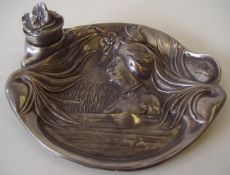 A 20th century Art Nouveau pewter plaque / inkwell tray decorated in relief of a girl with long
