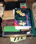 Two boxes of books and a metal gardening worker