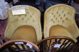 A pair of Victorian style yellow velour tub armchairs having button backed upholstery and turned