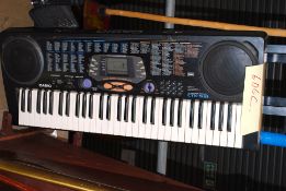 A Casio electronic piano keyboard instrument with stand