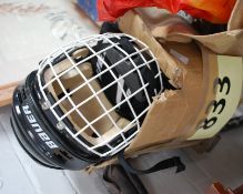 2 Ice Hockey helmets together with ice hockey gloves by Bauer