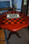 An occasional table with inlaid chess board to top, standing on a tripod base