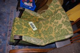 A vintage yellow and green upholstered wingback armchair.