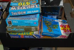A box of vintage and 20th century jigsaw puzzles to include wooden examples, Waddingtons and others