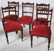 A set of 4 Edwardian mahogany dining chairs having turned legs with red velour set and spindle